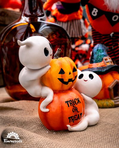 Figurines de fantômes sur citrouille décorée pour Halloween.